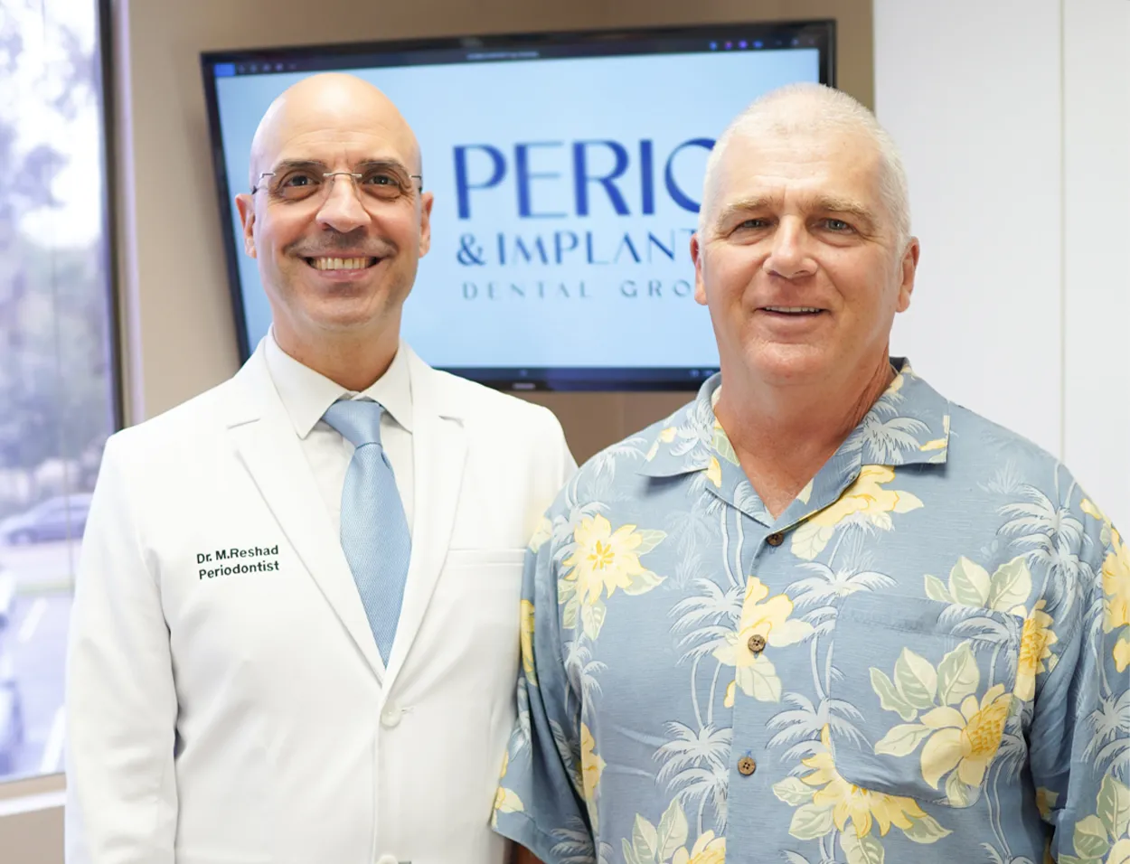 Dr. Reshad with a patient at OC Perio & Implants Dental Group
